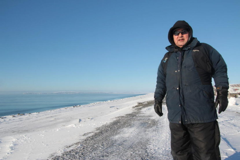 Eugene Asicksik, on the berm he and others built between village and the waters of the Norton Sound.