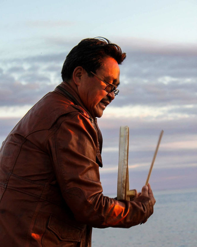 Anda Poulsen plays the traditional Inuit drum and sings the old songs by the ocean in Nuuk. A family therapist, he started a support group for parents who had lost a child to suicide. Courtesy of Anda Poulsen