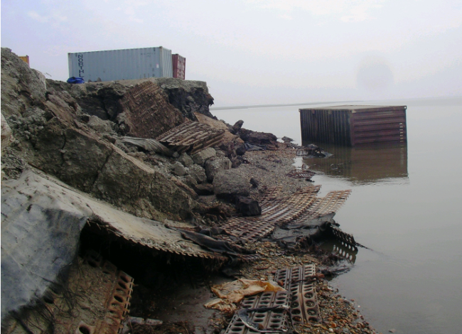 A steel storage container slid into the water after erosion chewed away at this bank in Newtok.