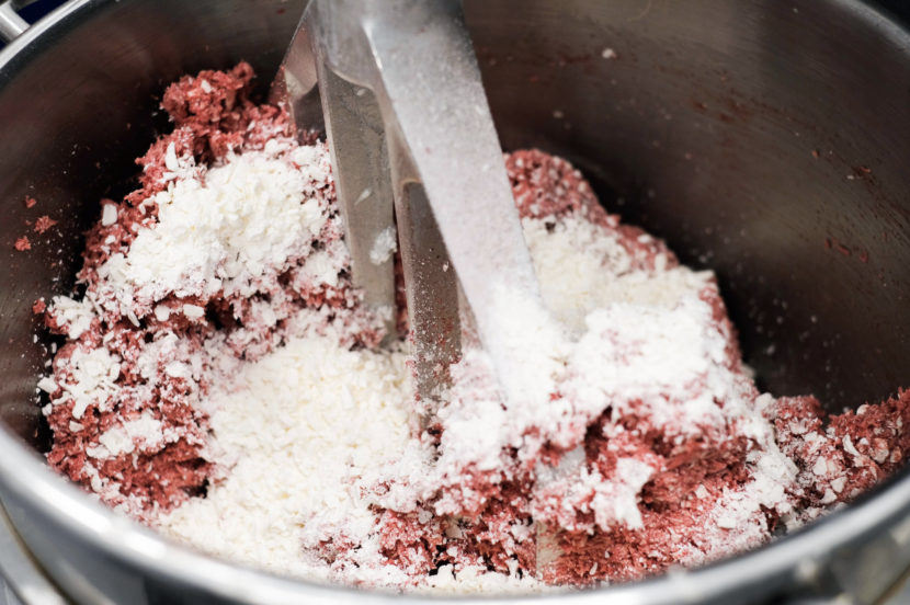 To mimic beef fat, Impossible Foods' meat-free burger uses flecks of coconut oil that are solid at room temperature and melt when cooked.
