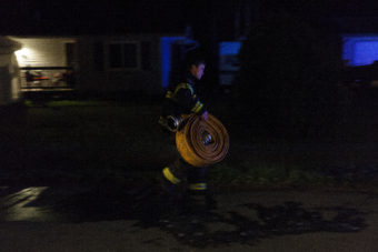 Firefighters work to extinguish a house fire on Cascade Street on July 8, 2016 in Juneau, Alaska.