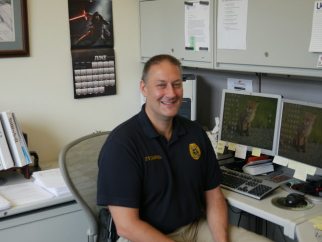 JPD Lieutenant David Campbell at his desk. Thursday, June 30, 2016. (Photo by Quinton Chandler/KTOO)