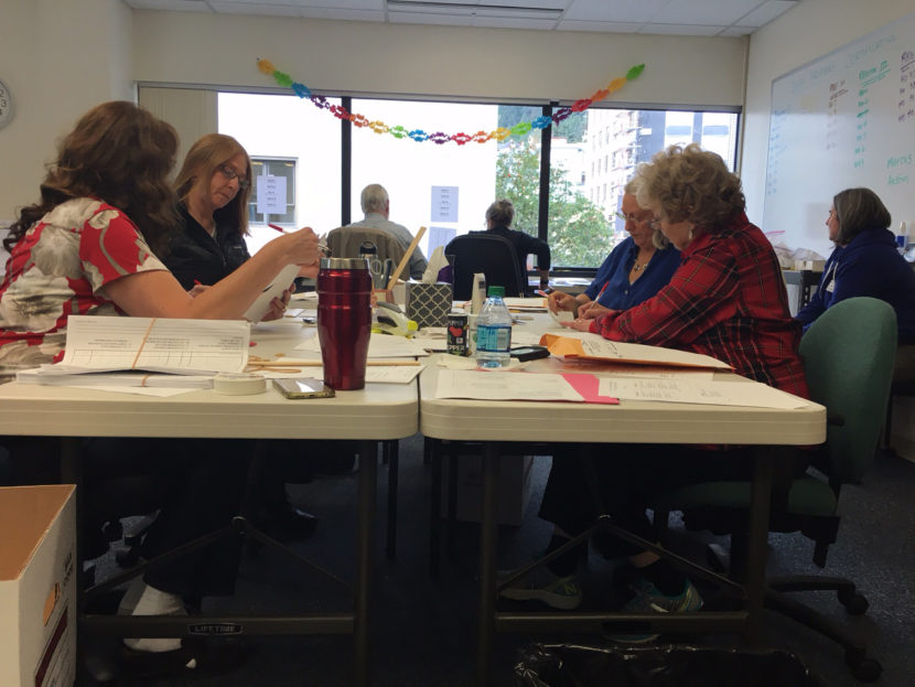 Election review board members work to certify the primary results at the Alaska Division of Elections office in Juneau, Aug. 30, 2016. (By Andrew Kitchenman/KTOO)