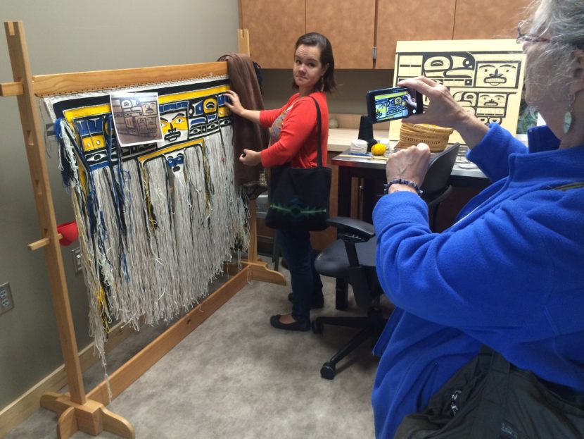 Lily Hope talks about Chilkat Weaving with art walk participant Cornelia Seckel. 
