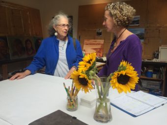 Art walk participant Cornelia Seckel and MK MacNaughton talk in MacNaughton's studio Sketch. (Photo by Scott Burton/KTOO). 