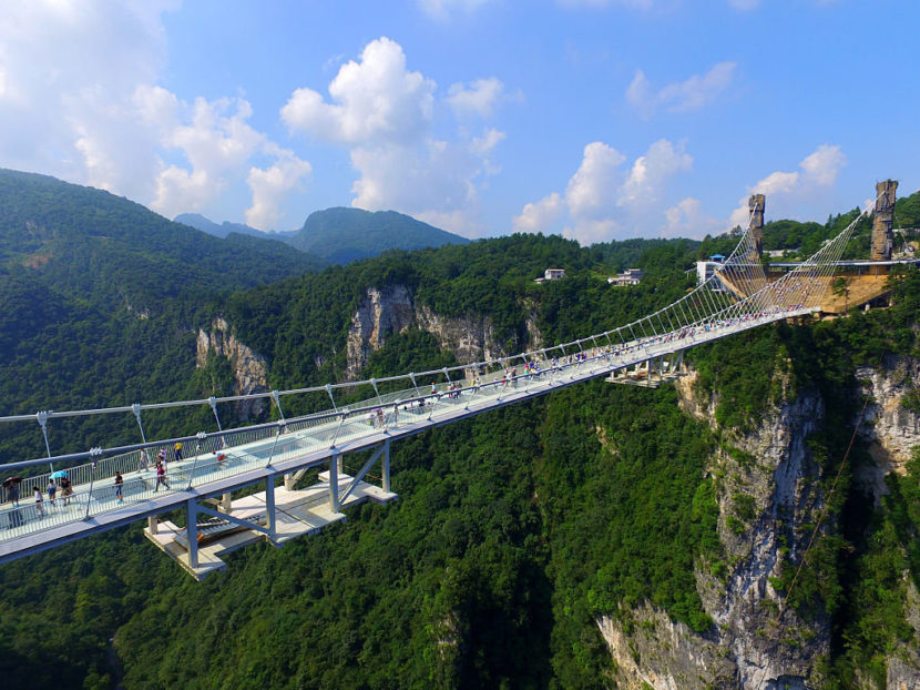 An aerial photo shows tourists visiting the glass-bottom bridge at Zhangjiajie Grand Canyon on Saturday. Visual China Group via Getty