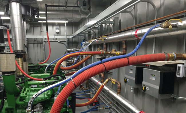 Wires, tubes, John Deere engines and other equipment fill the inside of Perryville's new powerhouse. (Photo by Annie Feidt, Alaska's Energy Desk - Anchorage)
