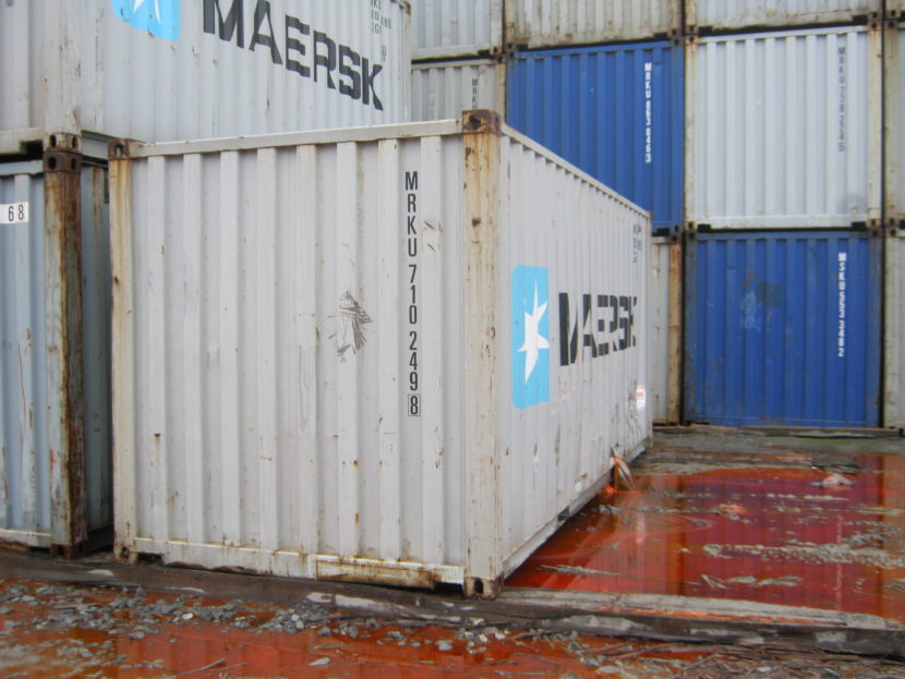Fish oil pours out of a punctured shipping container. (David Toonan/U.S. Coast Guard)