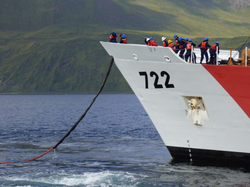 Members of the Coast Guard secure the Emergency Towing System. (Zoe Sobel/ KUCB)