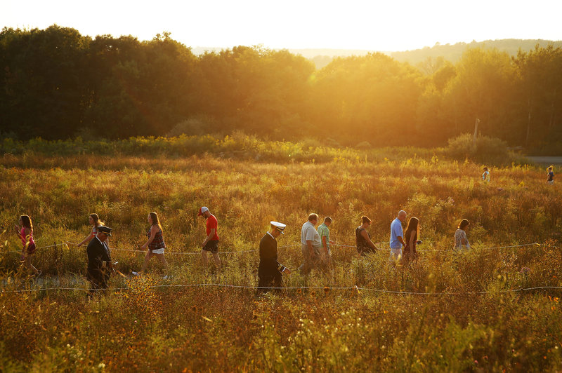 Visitors make their way through the Flight 93 National Memorial before lit candles are carried to the Wall of Names in memory of the passengers and crew of Flight 93, at the Flight 93 National Memorial in Shanksville, Pa. Jared Wickerham/AP