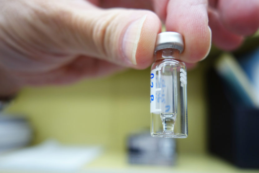 Bob Topmiller, chief of toxicology at the Hamilton County Coroner's Office, holds a small vial containing carfentanil extracted from a sample of blood. Jake Harper/Side Effects Public Media