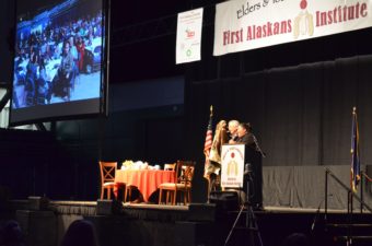 Liz Medicine Crow, president and CEO of First Alaskans Institute, and board chair Willie Hensley give opening remarks at the 33rd annual Elders and Youth conference in Fairbanks. (Photo by Jennifer Canfield)
