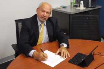 British Columbia Mines Minster Bill Bennett signs a document on Thursday that promises to cooperate on monitoring and protecting water quality. (Photo courtesy B.B. Ministry of Energy and Mines)
