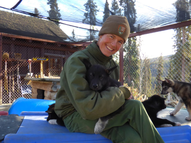 Jennifer Raffaeli plays with the kennel's newest members. (Zoë Sobel/KUCB)