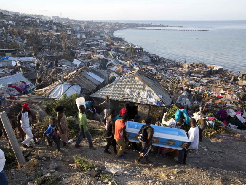 Residents carry a coffin containing the remains of a pregnant woman killed by Hurricane Matthew, in Jeremie, Haiti. People across southwest Haiti are salvaging what they can from wreckage the Category 4 storm caused. Dieu Nalio Chery/AP