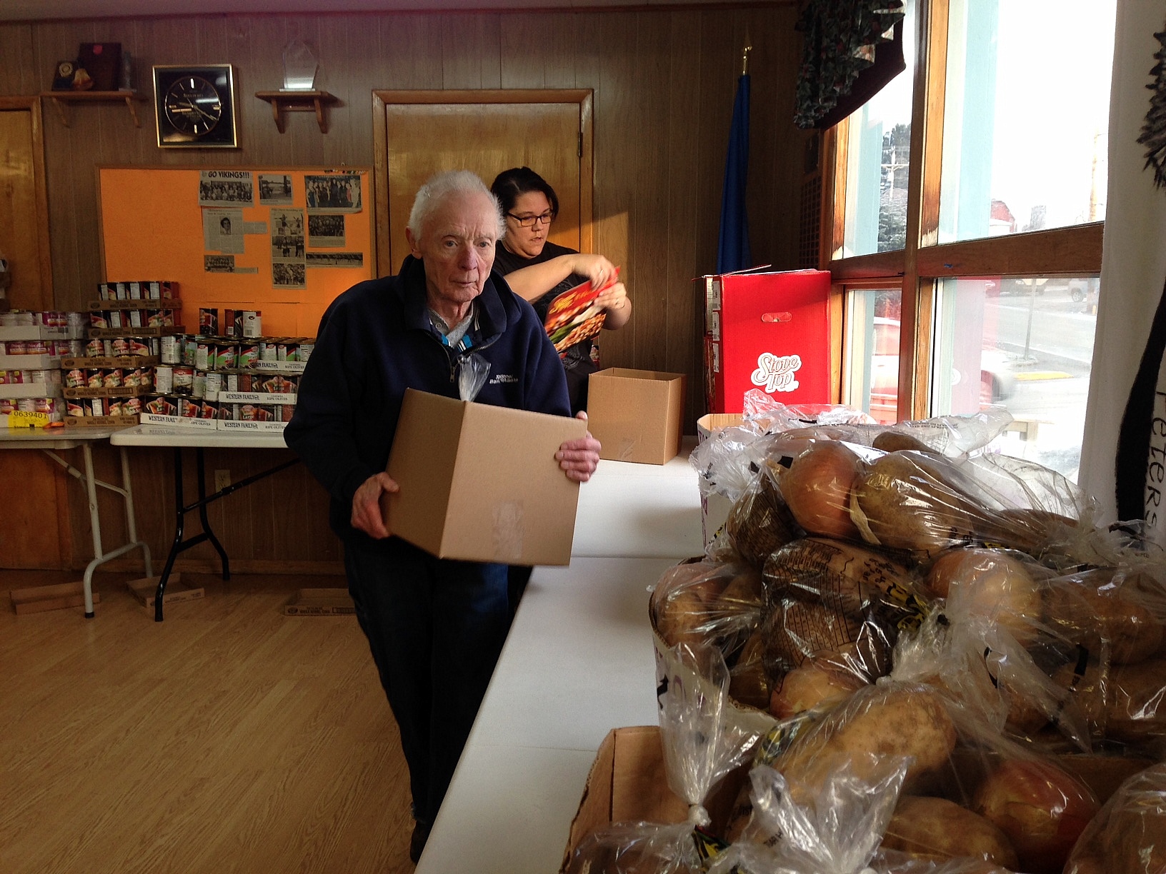 Volunteers Steve Homer and Mysti Birks pack Thanksgiving boxes for the Salvation Army Church. (Photo by Angela Denning/KFSK)