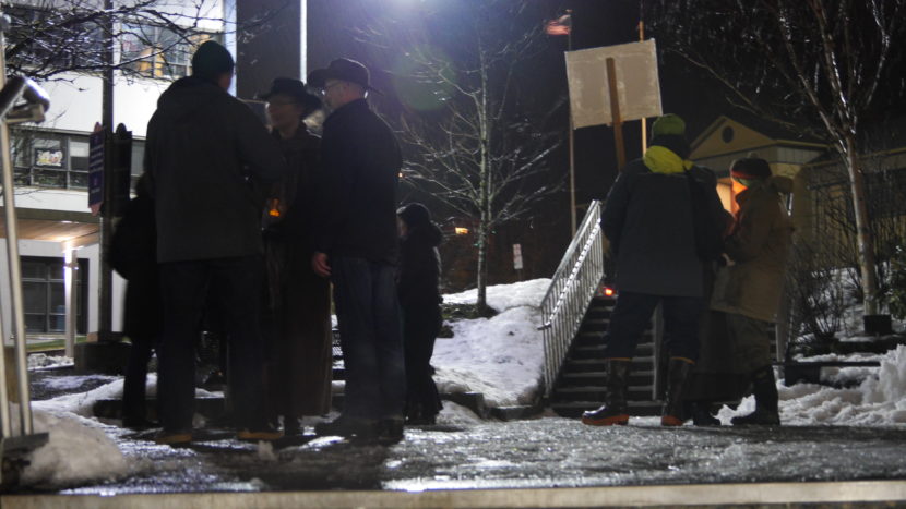 A few participants mill in front of the state Capitol building on Sunday, after a vigil asking Alaska's electors not to vote for Donald Trump. (Photo by Quinton Chandler/KTOO)