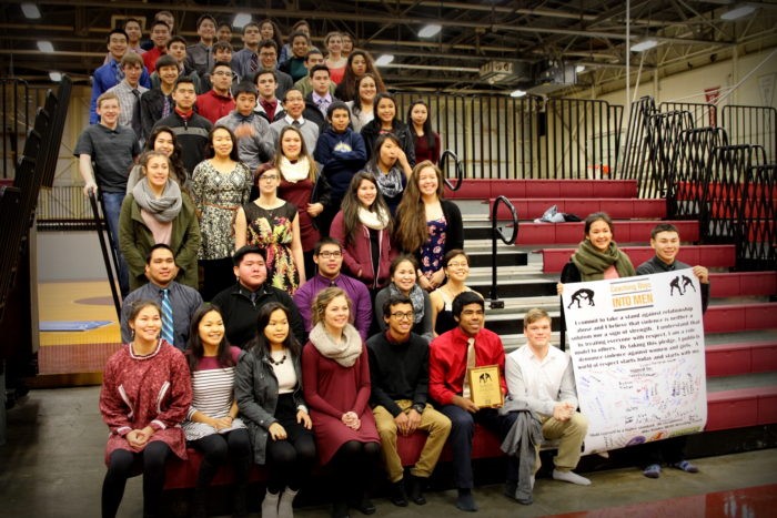 The Mt. Edgecumbe High School wrestling team. Emory Johnson helps hold up the poster. (Emily Russell/KCAW)