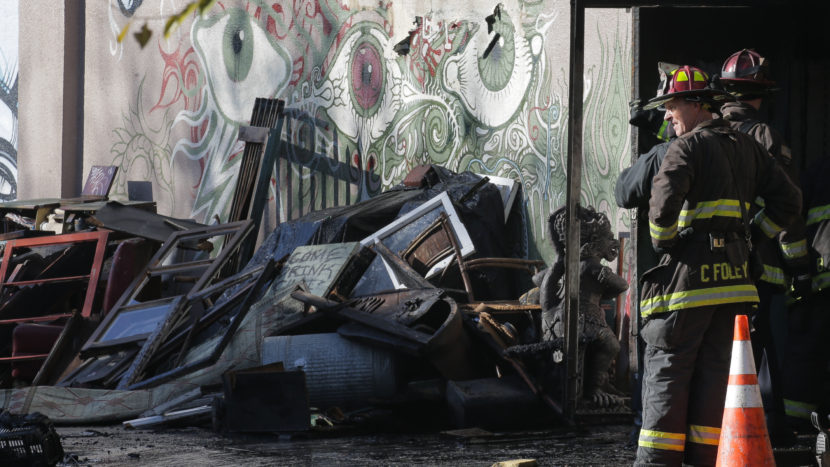 A collapsed roof and debris slowed down the recovery efforts of firefighters on Dec. 3 following a fire that killed at least 30 people at a warehouse in Oakland, Calif. Elijah Nouvelage/Getty Images