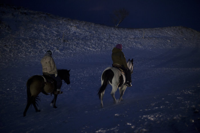 Protesters head back to camp after an evening ceremony honoring the of veterans making their way to join the ranks. While some have been trickling in throughout the week, up to 2,000 are said to be expected to arrive this weekend. Celia Talbot Tobin for NPR