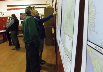 Petersburg resident Jeff Meucci points to a lands map while Ed Wood looks on during a meeting on Alaska Mental Health Trust Land Office timber sales. (Photo by Angela Denning/KFSK)