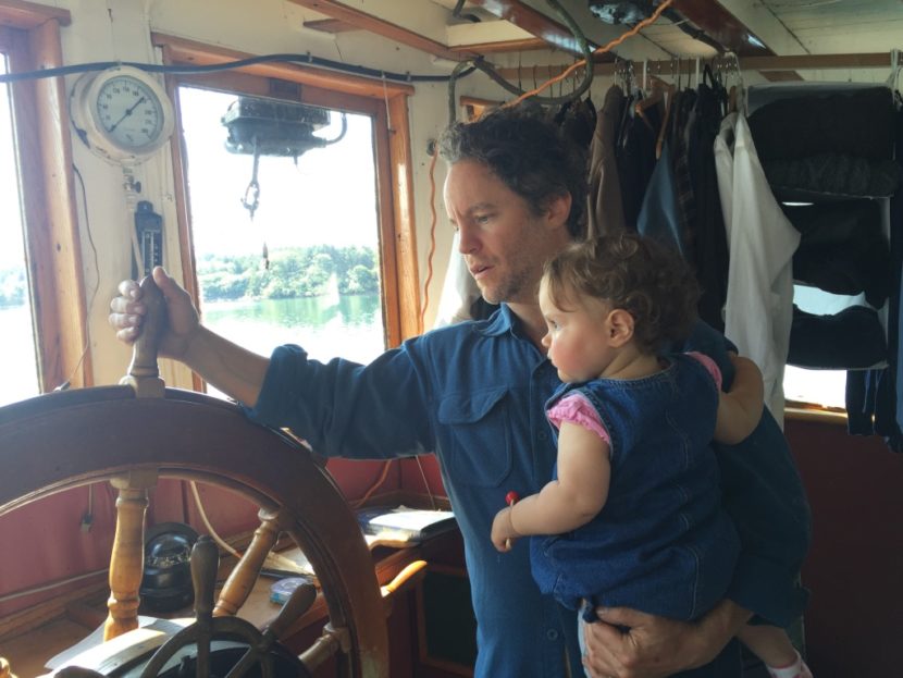 Brendan Jones, pictured with his daughter Haley, has won the Alaskana Award for his debut novel, “The Alaskan Laundry.” The book’s protagonist, like Jones, refurbishes a tugboat. (Photo by Emily Kwong/KCAW photo)