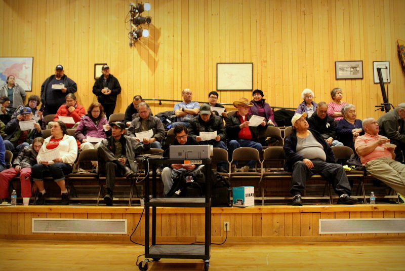 A crowd of Shee Atiká shareholders look over the corporation’s financial statements.