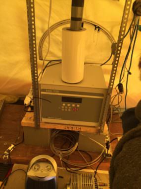 The beta attenuation monitor, or BAM, sits inside a heated tent. The unit draws in outside air through a stack that extends through the tent ceiling.
