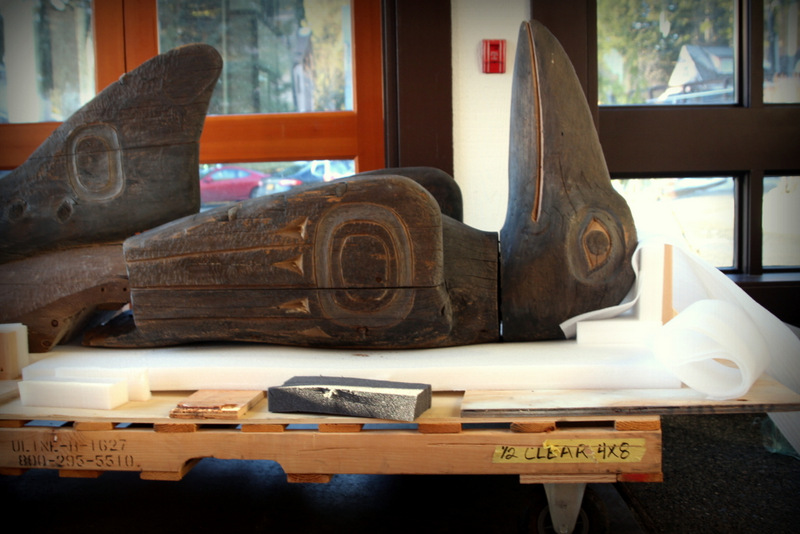 The top of the Raven Shark totem pole lies in Totem Hall at Sitka National Historical Park. (Photo by Emily Russell/KCAW)
