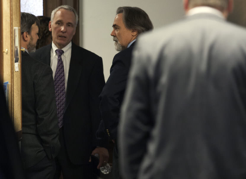 Lobbyists Kevin Jardell and Dan Seckers talk to Alaska Department of Revenue Commissioner Randall Hoffbeck during a break in a hearing on a state House oil tax credit bill on Wednesday, March 22, 2017, in Juneau, Alaska. (Photo by Rashah McChesney/Alaska's Energy Desk)