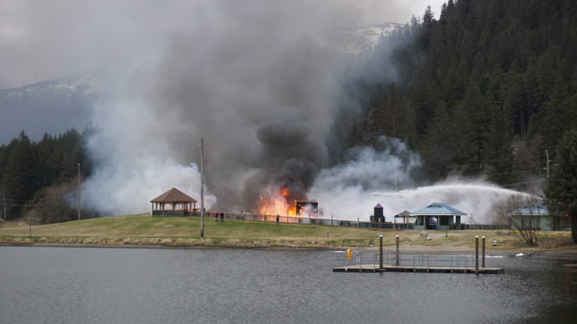 Firefighters spray down a fire on Monday, April 24, 2017, at the playground near Twin Lakes. (Photo by Kelli Burkinshaw/KTOO)