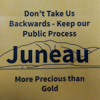 Anti-mining critics handed out stickers like these at a City and Borough Juneau Assembly committee meeting
