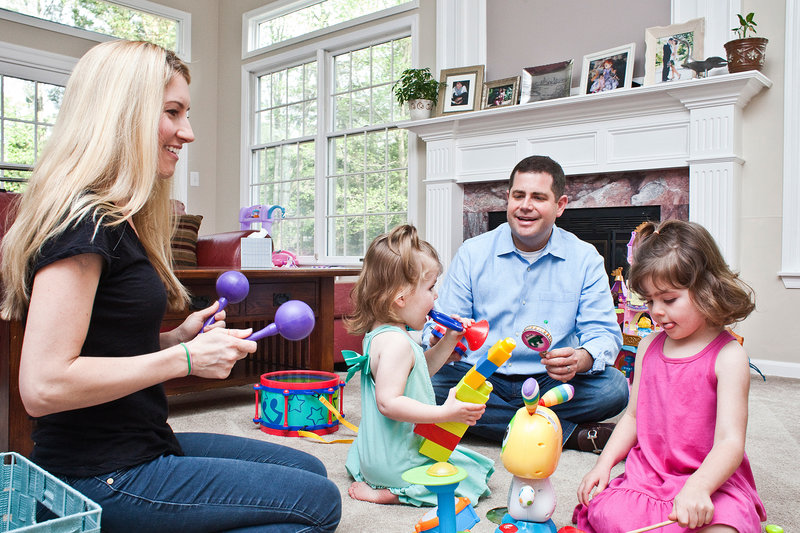Larry and Carolyn Bloomstein play with their daughters Aria, 2, (left) and Hailey, 5, at home in New Jersey.