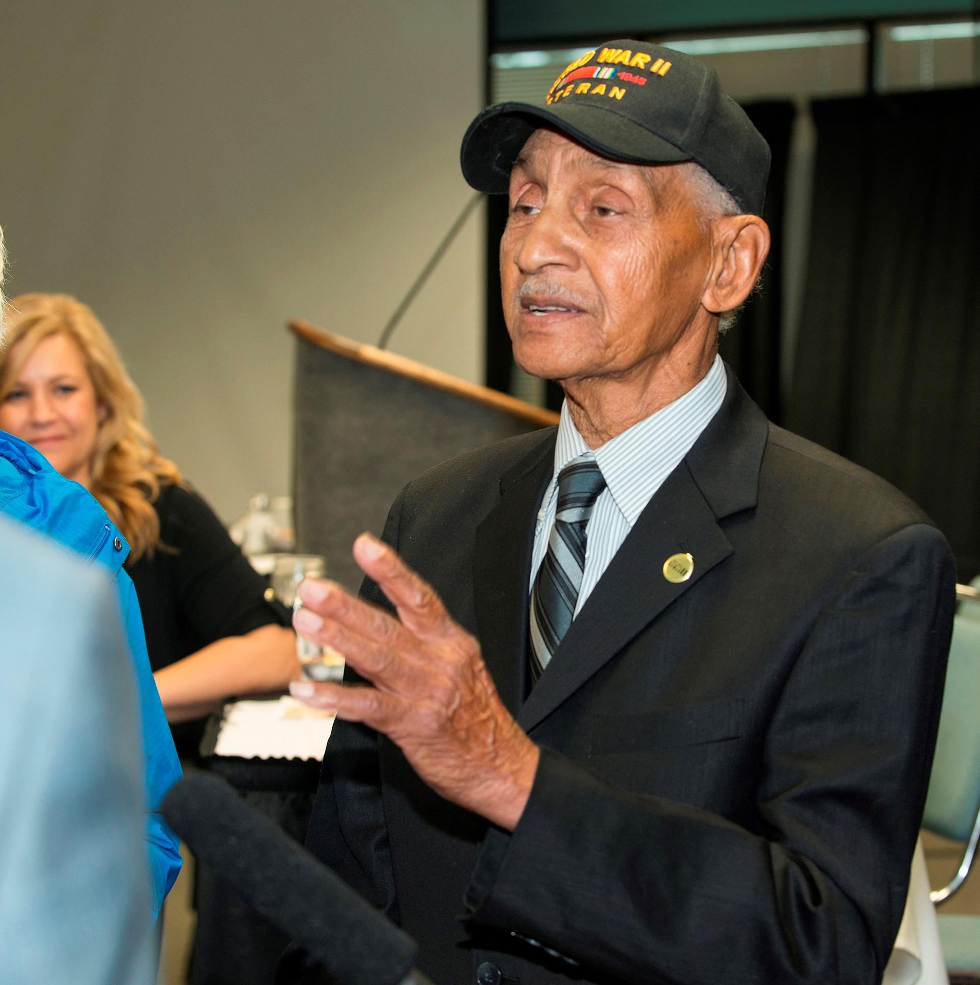Leonard Larkins talks with reporters after Tuesday's chamber meeting, as program presenter Meadow Bailey looks on. (Photo courtesy Greg Martin / Greater Fairbanks Chamber of Commerce)