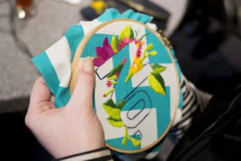 Melissa Griffiths works on a piece of embroidery for the Persisters art show happening Friday, May 5, 2017 at the Rockwell back room. (Photo by Annie Bartholomew/KTOO)