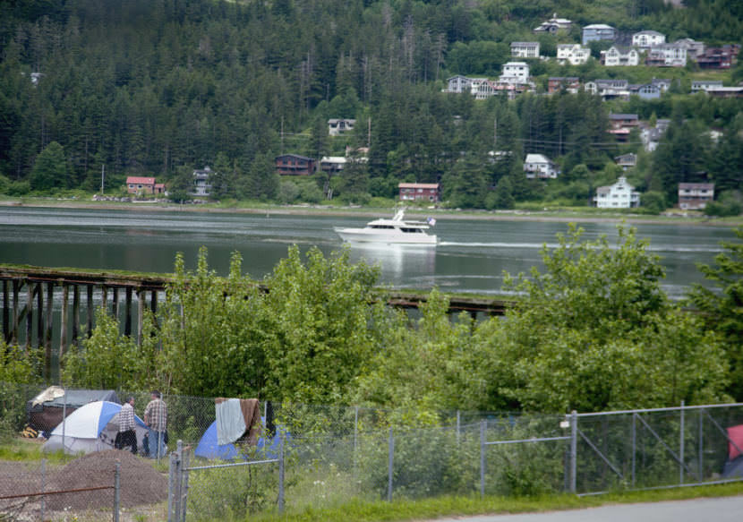 Campers gather near a small group of tents about noon Thursday, June 8, 2017, near the 300 block of Egan Drive in Juneau. (Photo by Tripp J Crouse/KTOO)