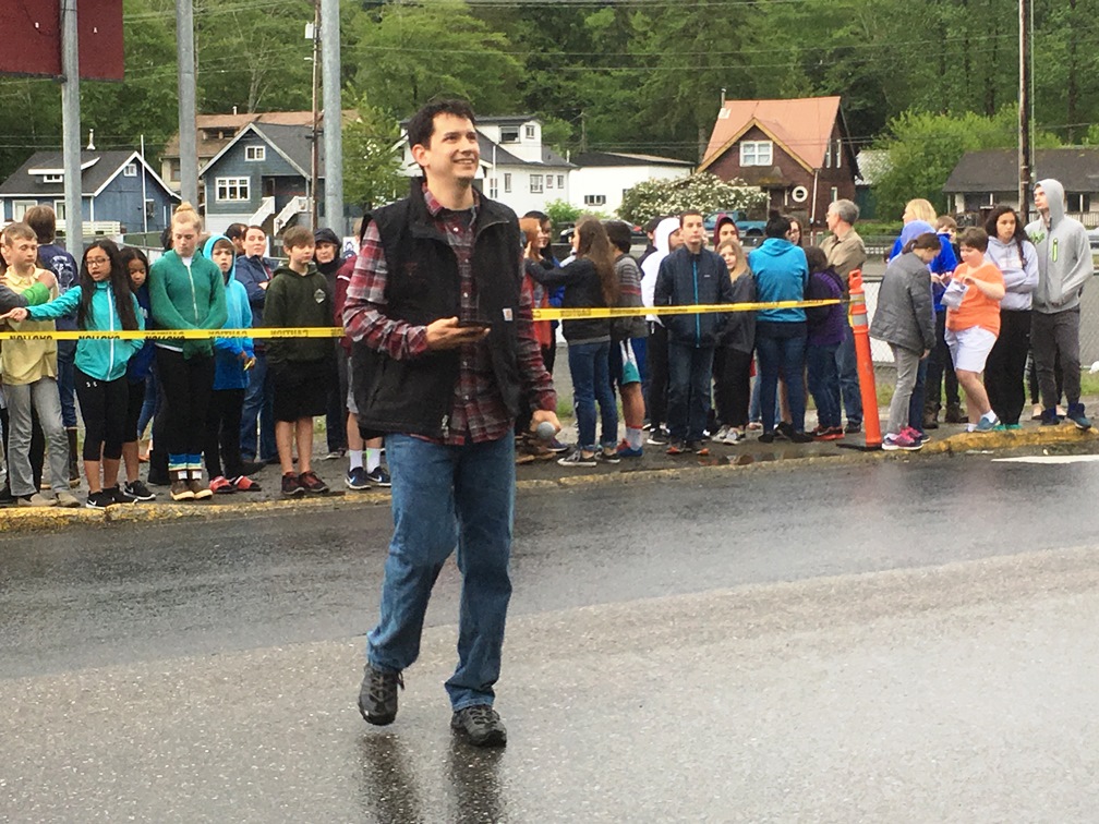 Carver Kelly White watches the Pathfinder totem pole as it’s raised. (Photo by Leila Kheiry/KRBD)