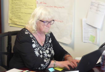 Hoonah City Schools Superintendent PJ Ford Slack finishes a school board report on Friday, June 9, 2017. Photo by Quinton Chandler/KTOO)
