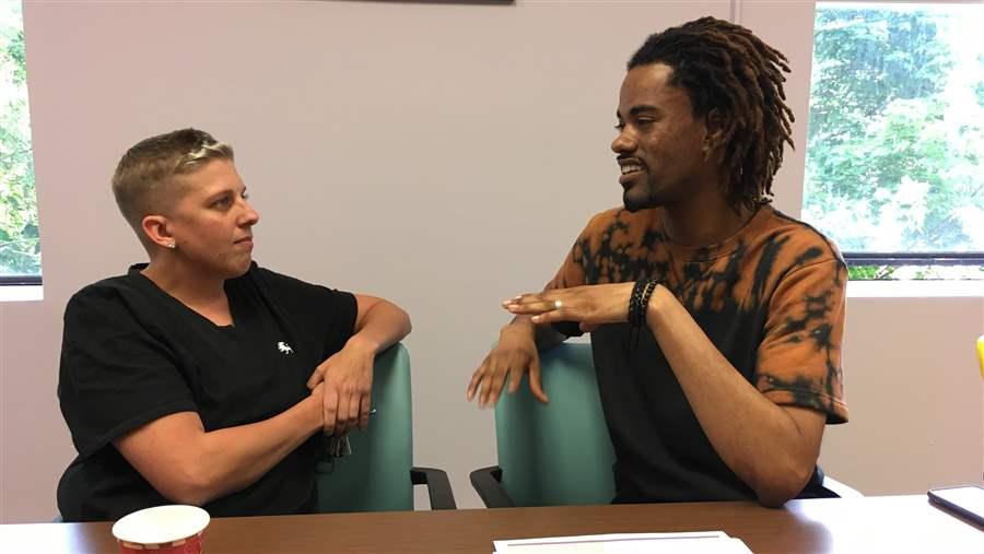 Community Health Action of Staten Island recovery coaches Jamie Longo, left, and Tarik Arafat discuss care for people recovering from drug addiction and alcoholism in New York. In recovery themselves, they are among the growing number of trained addiction professionals on the front lines of the opioid epidemic. (Photo courtesy The Pew Charitable Trusts)