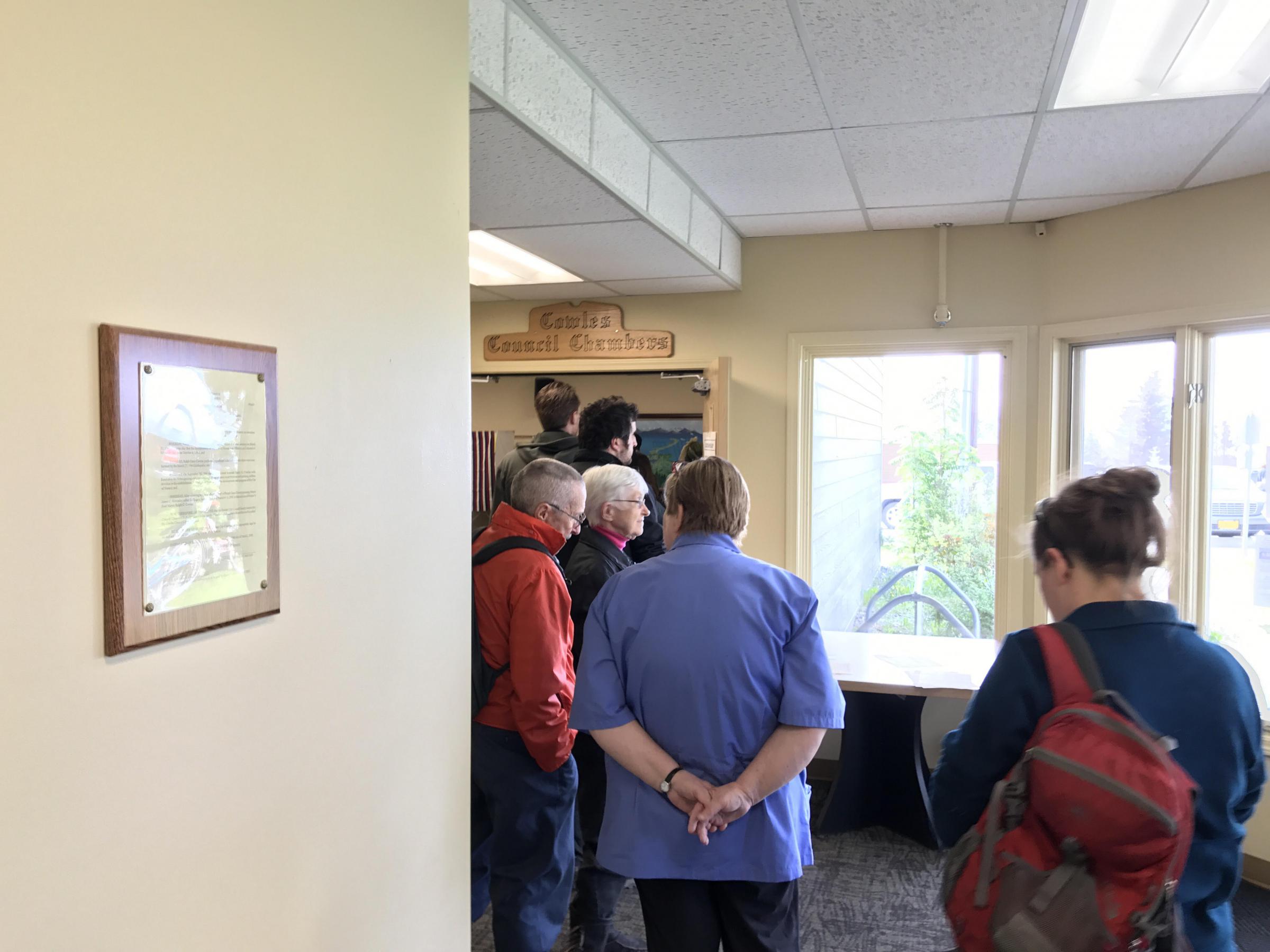 Voters line up at the polls to cast their decision in the recall election of three Homer City Council members. The unofficial results are too close to call until the vote can be certified Friday. (Photo by Aaron Bolton/KBBI)
