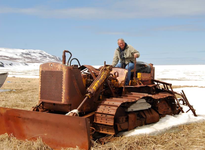 Mike Coffey poses on an old bulldozer in the Bethel area in 2009. He's retiring from his job as Department of Transportation Southcoast Region director. (Photo courtesy Department of Transportation)