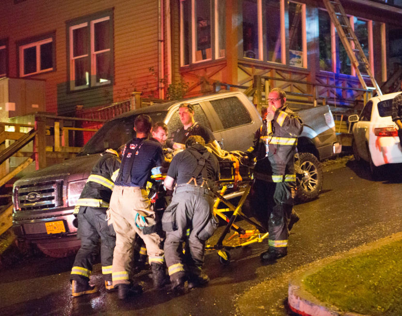 Capital City Fire/Rescue personnel perform CPR on 1 of the 3 people transported to Bartlett Regional Hospital during the house fire at 526 Seward Street on Sept. 17, 2017. (Photo courtesy of Brian Wallace)
