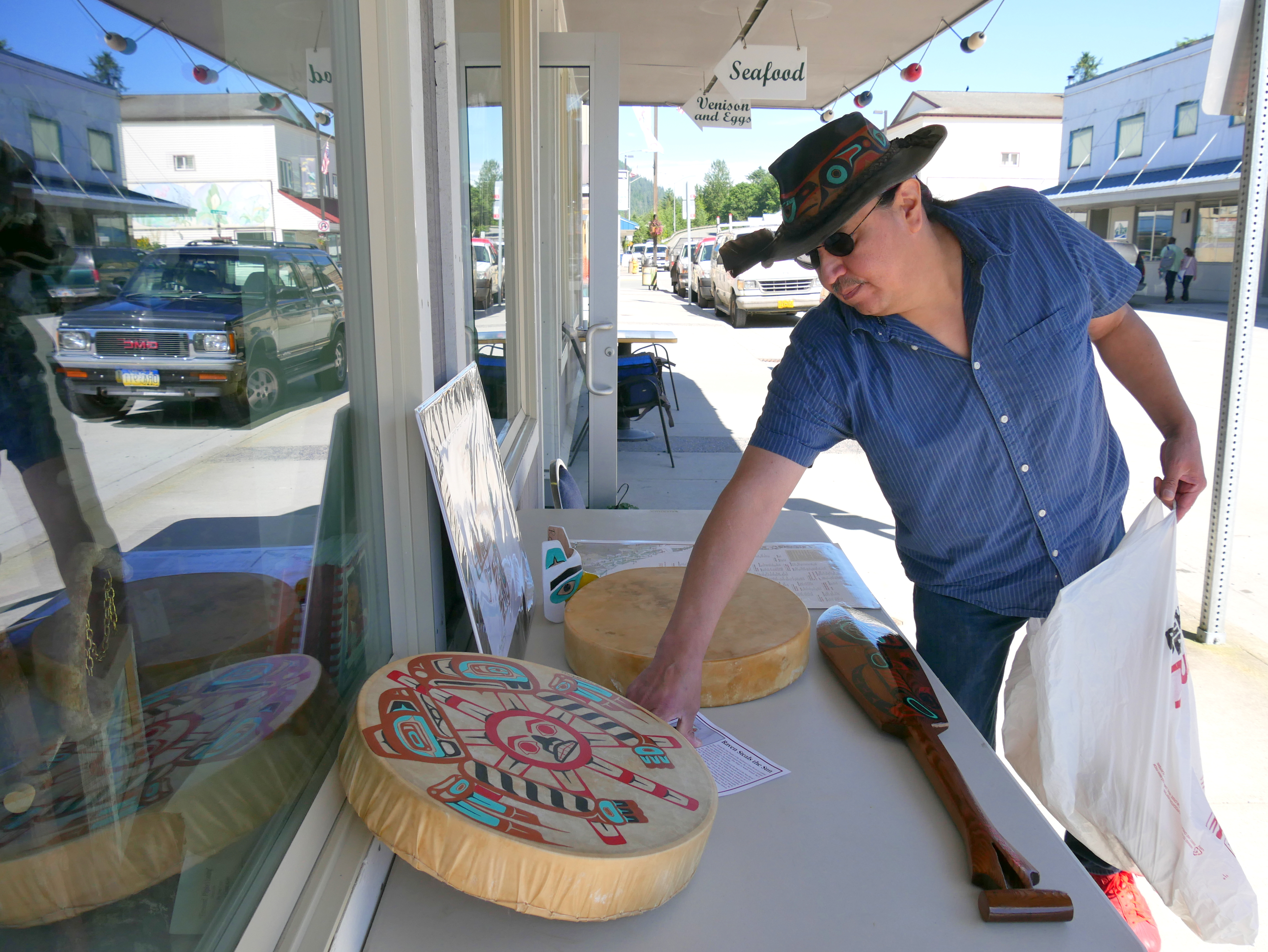 Ross Nannauck III sets up his artwork to sell in downtown Petersburg. (Photo by Angela Denning/KFSK)
