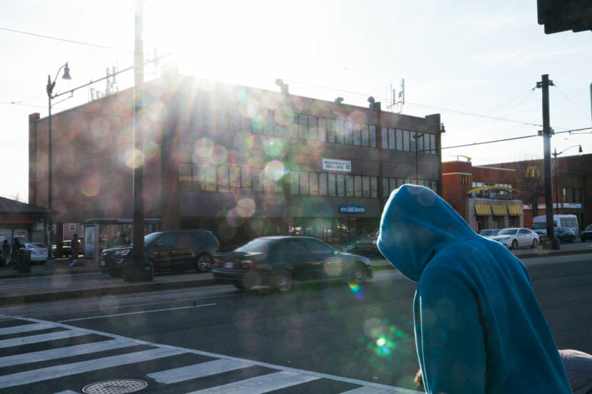 A man walks on Benning Road in Northeast Washington, D.C. in front of the Greater Northeast Medical Center, where Dr. Edwin Chapman works. (Photo by Claire Harbage/NPR)