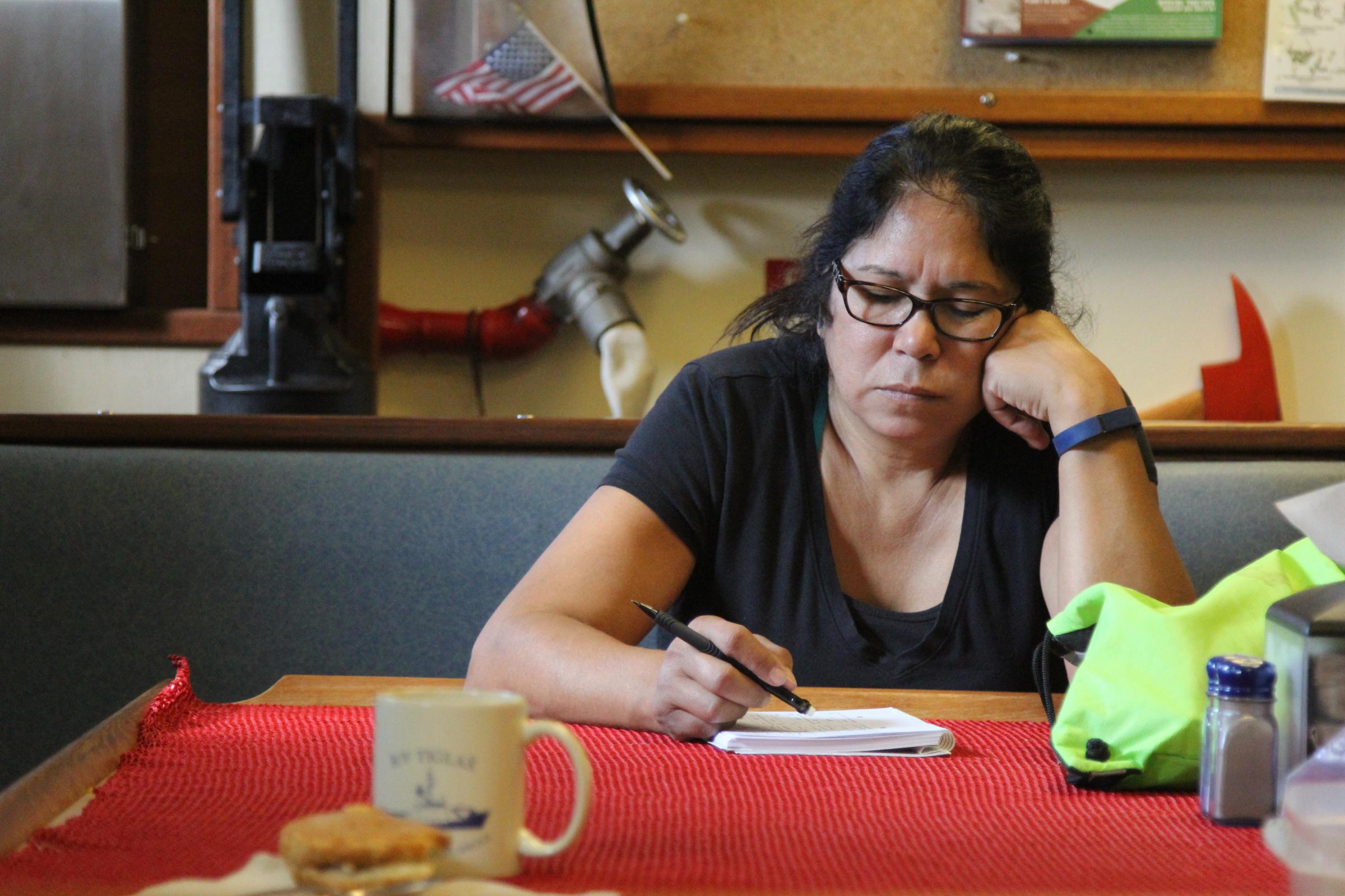 Theresa Deal passes time on the Tiglax playing Sudoko. (Photo by Zoë Sobel/KUCB)
