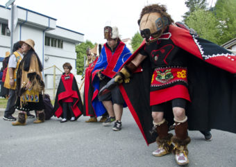 A dancer with the Gajaa Heen Dancers wears a wooden wolf mask.