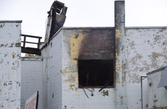 A busted out window at the back of the apartments.