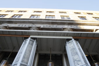 A wooden platform above the doorway of the Alaska State Capitol Building protects entrants from falling debris from the portico.