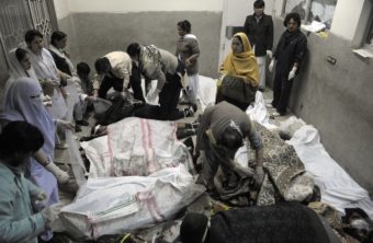 Rescue teams attend the bodies of victims who died in a marketplace bomb blast in Quetta, Pakistan, on Saturday. Banaras Khan/AFP/Getty