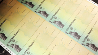 U.S. Treasury checks are run through a printer. William Thomas Cain/Getty Images